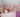 Colorful wildflower wall decal featuring a variety of hand-painted flowers in shades of red, pink, yellow, blue, and white. The flowers are arranged in whimsical vertical stems against a soft lavender or mauve paneled background, creating a playful and artistic springtime meadow effect—ideal for nurseries or children's rooms.