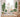 Hand-painted evergreen tree wall decal featuring a tall pine with layered green foliage and a textured brown trunk. Below, soft rounded bushes add depth and contrast, creating a peaceful forest scene—perfect for nursery or woodland-themed wall decor.